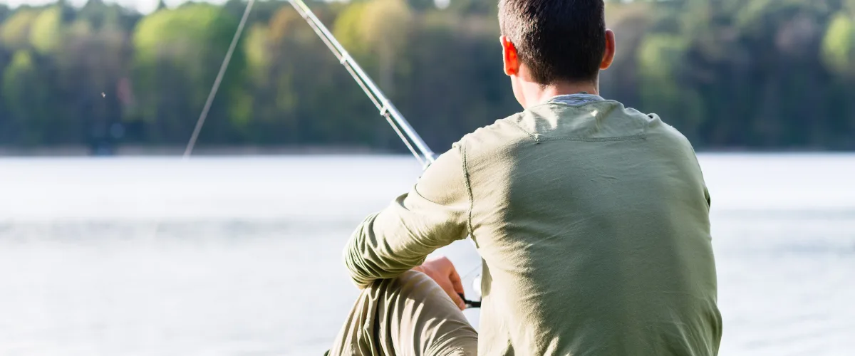 Angler bankside in spring sunshine